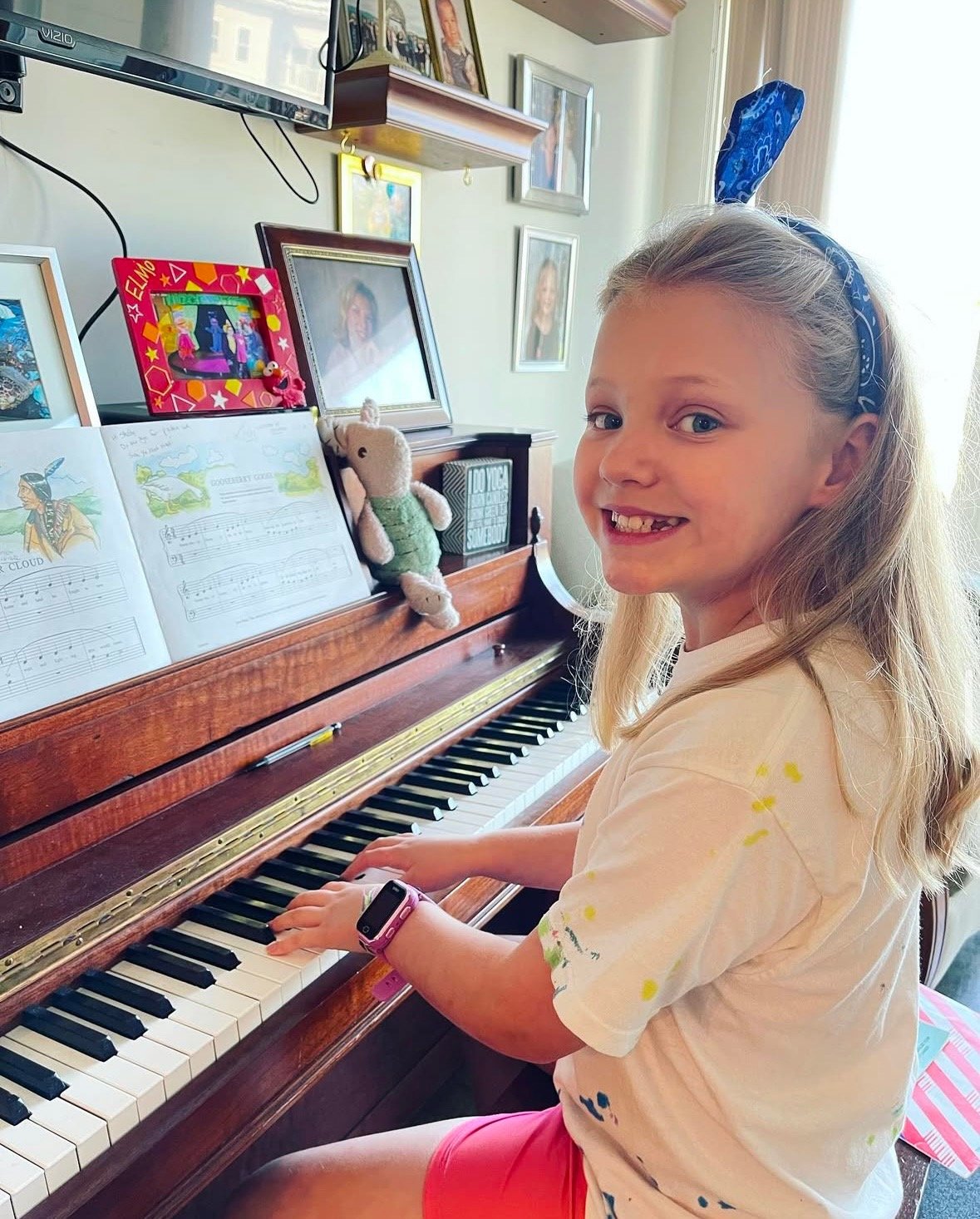 Young student smiling while taking a piano lesson at Michael Mingoia Music school in Patchogue, NY
